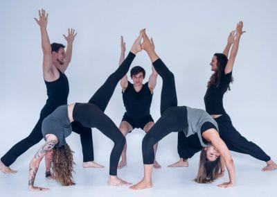 5 yoga teachers in different poses smiling at My vinyasa practice in Austin texas