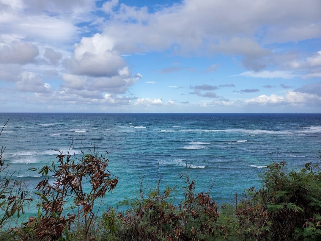 view of the pacific ocean from Captain Cook Hawaii under a blue and partly cloudy sky