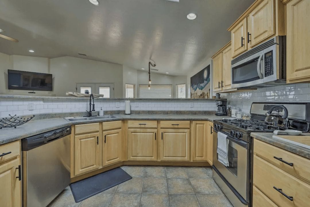 interior of a house kitchen in Arizona with a grey countertop and wood cabinets