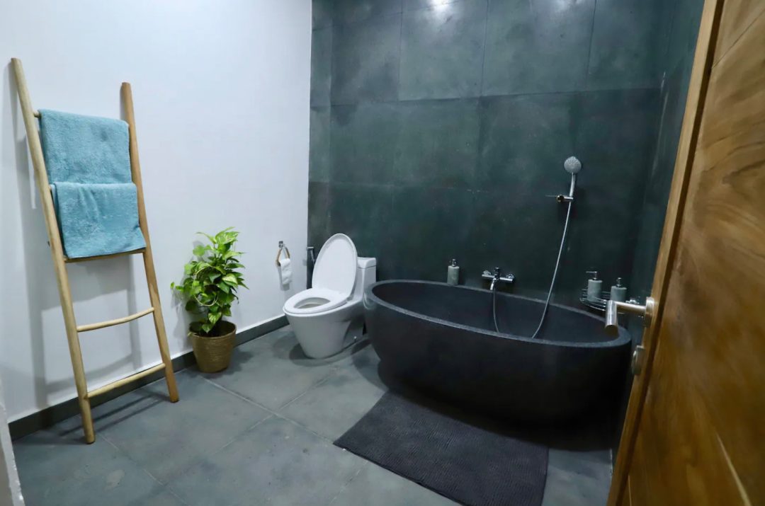 Minimalist stone bathroom with large bathtub