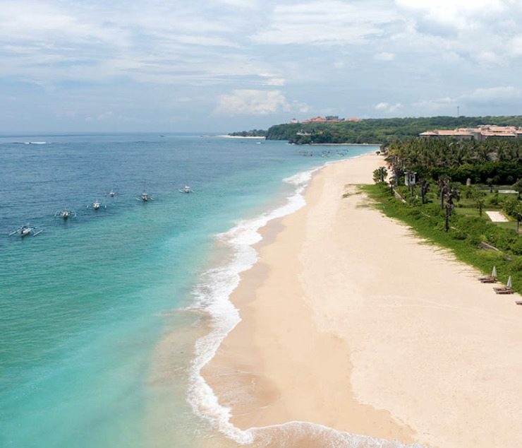 Blue scenic ocean, sandy beaches and lush greenery of Bali