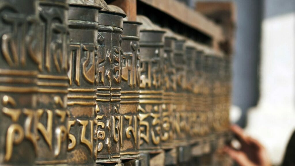 Brass pipes that are transcribed in Sanskrit are lined in a row.