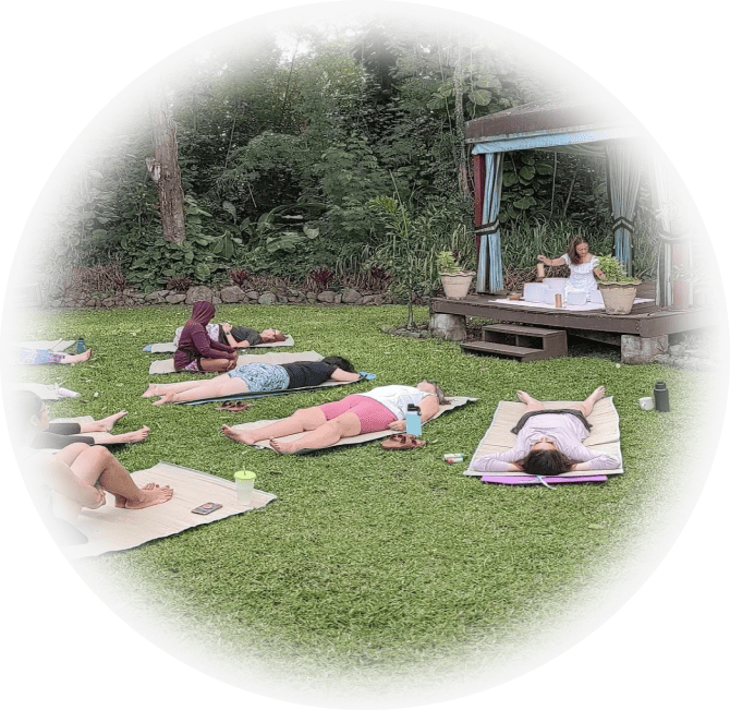 Events 5 A group of yogis laying on the grass in yoga mats.