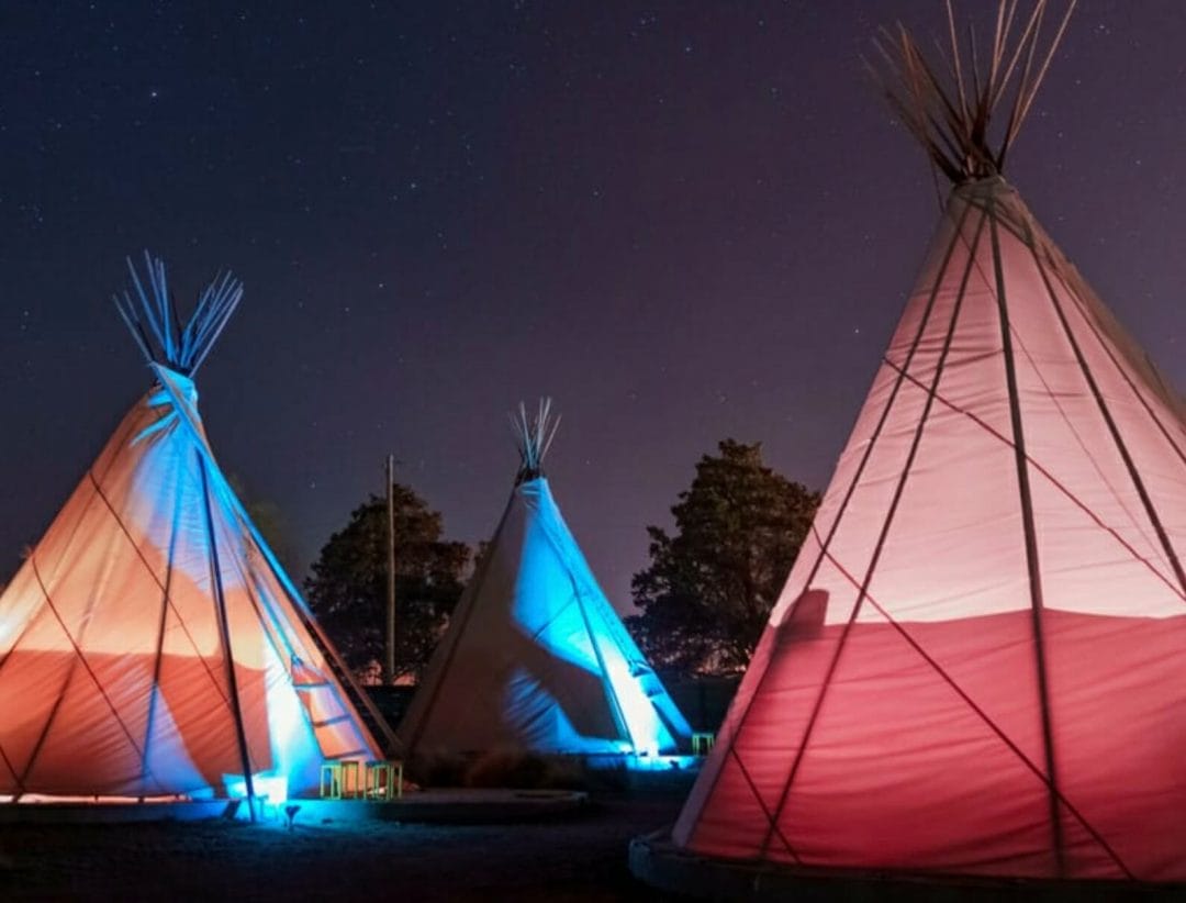 Teepees,Glowing,Under,A,Starry,Sky,At,Night,In,Marfa,