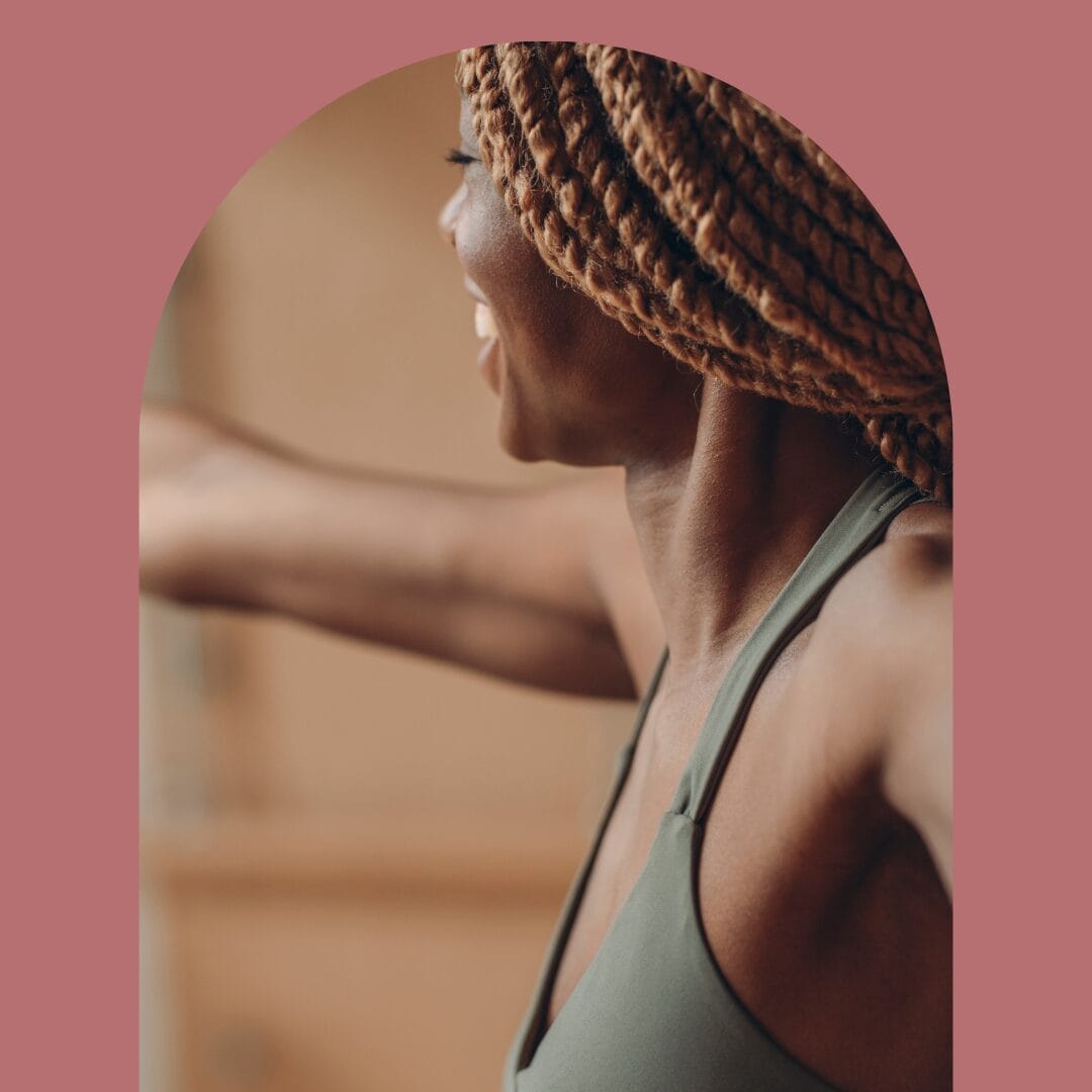 Woman in child's pose with a brass bowl on her sacrum receiving somatic therapy through yoga therapy.